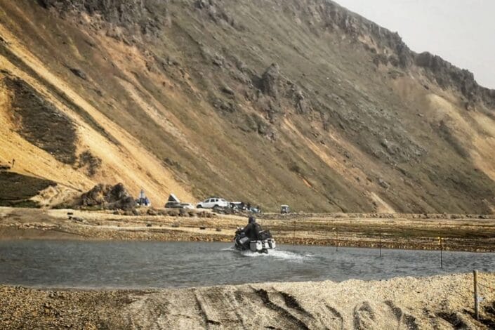 Motorcycle riding through the ford at Landmannalaugar