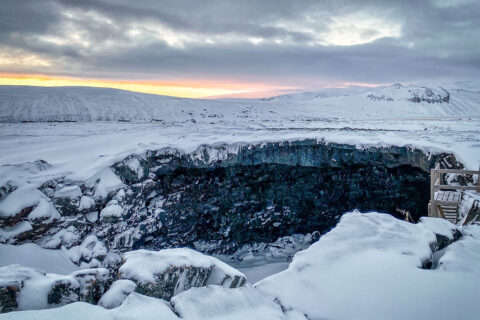 entrance to Vidgelmir lava cave in winter