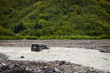 an off-road vehicle crossing a mountain river