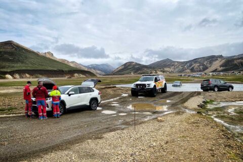 a car flooded next to a ford in Iceland highlands