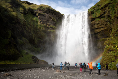 Tourists in front of Skogafoss waterfall