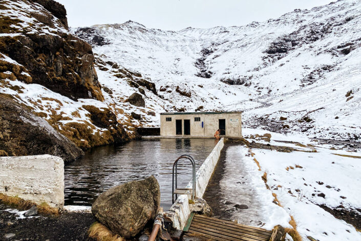 Seljavallalaug pool and snow-covered mountains in winter