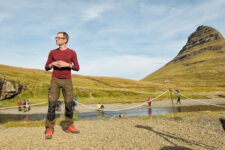 man near Kirkjufell, Iceland in summer