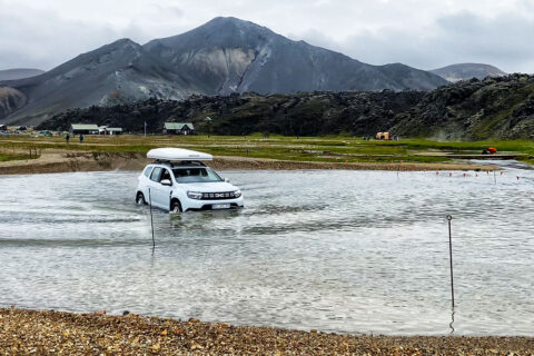 a car crossing the river ford in Landmannalaugar, Iceland
