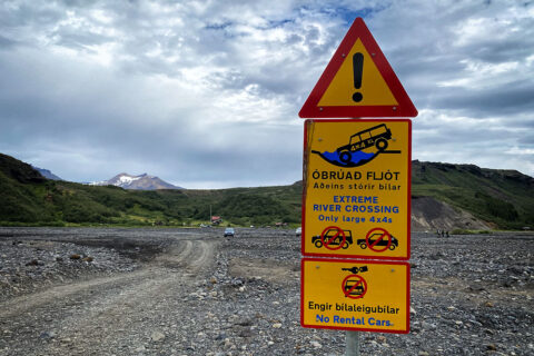 road signs warning against crossing the Krossa river ford in Iceland