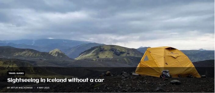 Yellow tent pitched in Iceland's highland interior on an overcast day, surrounded by grass, marsh and volcanic sand